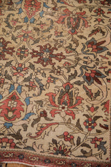 Corner detail of Antique Fereghan rug, showing repeating boteh border and time-softened lotus motifs on ivory.