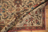 Antique Fereghan rug's ivory field displays staggered lotus, arabesques, and a boteh vine border.