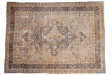 Vintage Distressed Kerman carpet, ornate medallion, scrolling vinery, dark navy, and antique ivory tones.