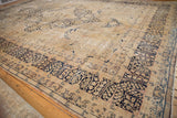 Detail of distressed Kerman carpet border with dark navy millefleur motifs on antique ivory ground.