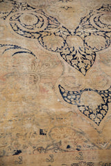 Vintage Distressed Kerman carpet detail: dark navy vinery on worn gold, showing foundation.