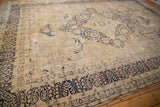 Distressed Kerman rug border with dark navy Four Season Garden design and faded floral field.