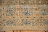 Distressed vintage Meshed rug border with blue geometric stars and exposed foundation.