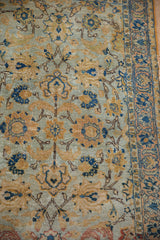 Distressed pile of Tabriz rug, with pale blue, gold palmettes, lotus motifs and border.