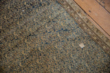 Antique Malayer rug detail: distressed navy and beige floral pattern, worn pile, exposed foundation, visible patch.