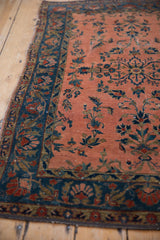 Antique Kashan rug field with dusty rose vinery and cobalt blue floral border.