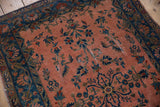 Antique Manchester Kashan rug close-up showing dusty rose field, cobalt floral vinery, and soft wear.