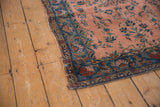 Antique Manchester Kashan rug corner: dusty rose field, cobalt blue vinery border.