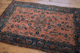 Antique Manchester Kashan rug corner with intricate floral border and dusty rose field.
