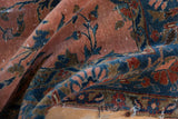 Aged dusty rose and cobalt blue Kashan pile detail with worn border and short fringe.