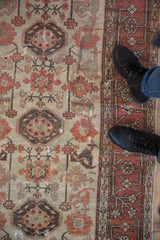 Distressed Hamadan rug with wide terracotta main border, rectilinear vine pattern, and soft aged pile.