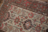 Decorative vintage distressed Hamadan rug detail, worn antique ivory pile with terracotta florals.