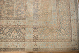 Meshed carpet corner with elaborate thousand flower motifs in pale copper and dusty blue.
