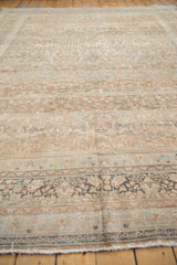Distressed pile and softened floral motifs in pale copper and dusty blue border.