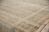 Distressed texture with pale copper and dusty blue floral motifs on the Meshed rug.