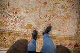 Antique Oushak carpet, circa 1910s, with worn rectilinear patterns and saffron yellow border.