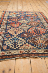 Antique Kuba rug detail: geometric tree-of-life motifs with serrated guls in indigo, madder red.