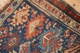 Close-up of geometric serrated guls and tree-of-life motifs in indigo, madder red, ivory.