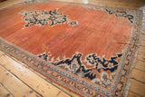 Abrashed terracotta field with bold navy and ivory medallion of the Vintage Mahal carpet.
