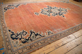 Vintage Persian Mahal rug corner: terracotta field, navy palmette border, and hand-knotted fringe.