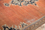 Detail of vintage Mahal rug's abrashed terracotta field, revealing knot heads and navy border.
