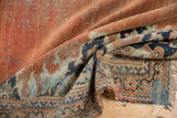 Vintage Persian Mahal fragment corner, revealing terracotta field, navy border, and original fringe.