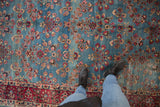 Hand knotted Persian Kerman carpet with sky blue abrashes, millefleur pattern, and a wine red border.
