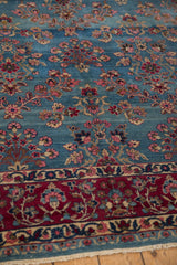 Wine red meandering vine border, sky blue millefleur field with visible abrashes.