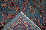Detail of Kerman carpet showing abrashed blue field with millefleur design, fringe, and reverse border.