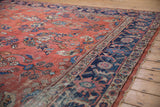 Distressed vintage Mahal carpet, abrashed brick red field, floral bouquets, and navy Herati border.