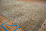 Faded beige and dusty blue floral patterns on a distressed Sivas carpet fragment.