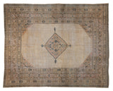 Distressed vintage Khorassan carpet, beige field, diamond medallion, blush, navy borders.
