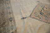 Vintage Distressed Khorassan carpet showing worn beige field and intricate charcoal inner border.