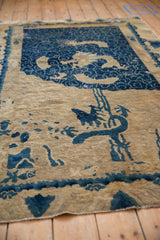 Unique pictorial dragon and wave design in cobalt blue on distressed antique Peking rug.