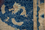 Distressed cobalt blue cloud pattern meeting beige wave border on antique Peking rug.
