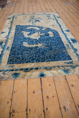 Distressed bottom corner of Antique Peking rug, worn cobalt blue field, ivory wave design.