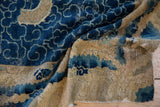 Storied distress on antique Peking rug, revealing cobalt blue cloudband and beige foundation.
