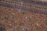 Antique Caucasian rug: geometric lattice of indigo blue and madder red boteh on ecru ground, with mostly even pile wear.