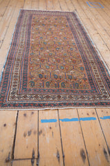 Antique Caucasian runner's madder red, blue, and ecru geometric borders and intact side selvage.
