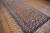 Antique Caucasian runner with intricate borders, repeating boteh lattice, and original blue selvages.