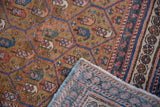 Antique Caucasian runner's worn surface with lattice boteh motif, revealing detailed foundation and blue selvages.