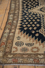 Distressed Malayer runner border with geometric patterns, rich navy field and visible boteh motifs.