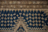 Distressed Malayer rug border detail with navy blue field and beige geometric patterns.