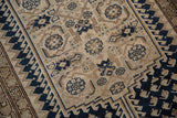 Distressed Malayer rug runner showing navy blue and beige Herati field with serrated border detail.