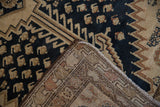 Close-up of Malayer rug with distressed navy boteh patterns, hand-knotted foundation, and selvage.
