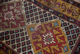 Textured wear showing knot heads and foundation on a geometric vintage Caucasian rug runner.