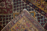 Folded corner of a vintage Caucasian runner reveals the hand-knotted back and worn pile.