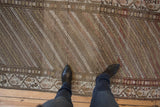 Even wear across the knot heads of a distressed Hamadan runner with a diagonal striped pattern.