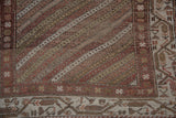 Junction of the boteh border and diagonally striated field on a distressed Hamadan runner.