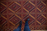 Detail of antique Beshir runner's red, navy, gold multi-paneled field with inverted medallions.